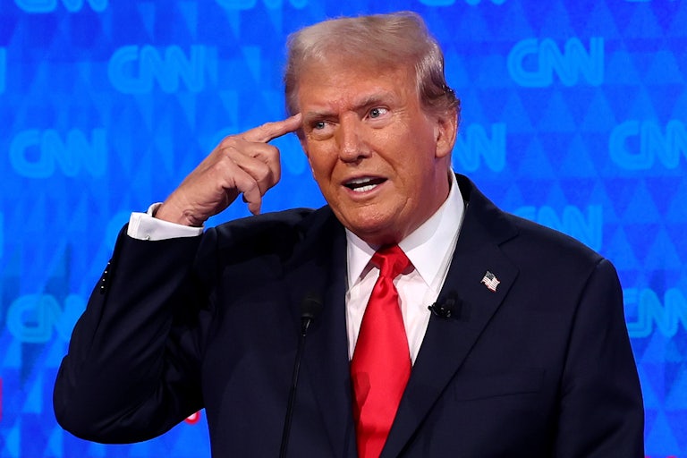 Donald Trump points to his own head