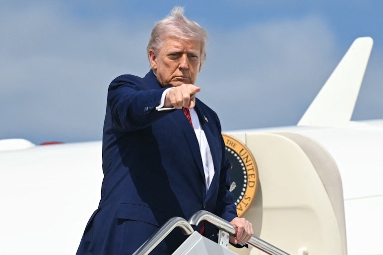 Donald Trump points while boarding Air Force One