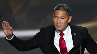 Hung Cao speaks at a podium.