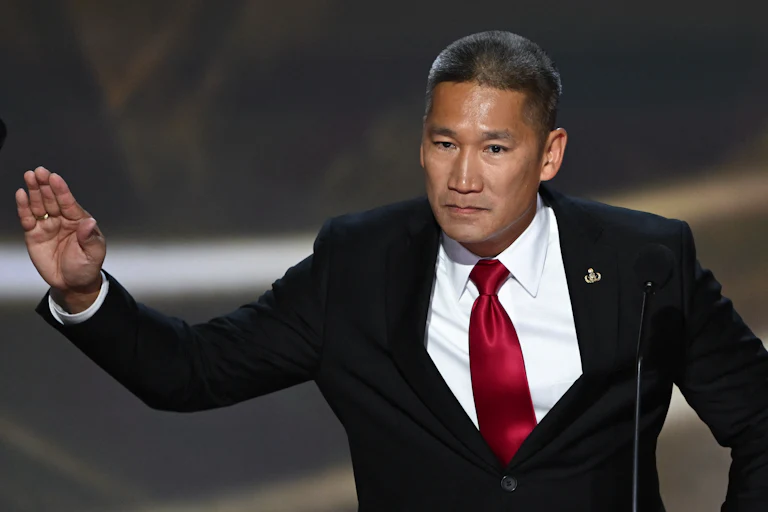 Hung Cao speaks at a podium.