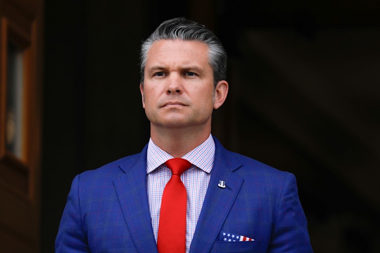 Defense Secretary Pete Hegseth stands outside the Pentagon