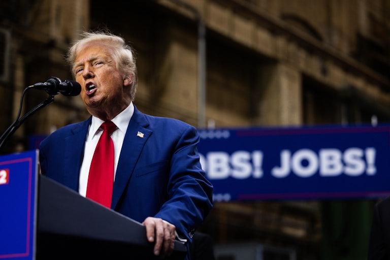 Donald Trump speaking at a lectern