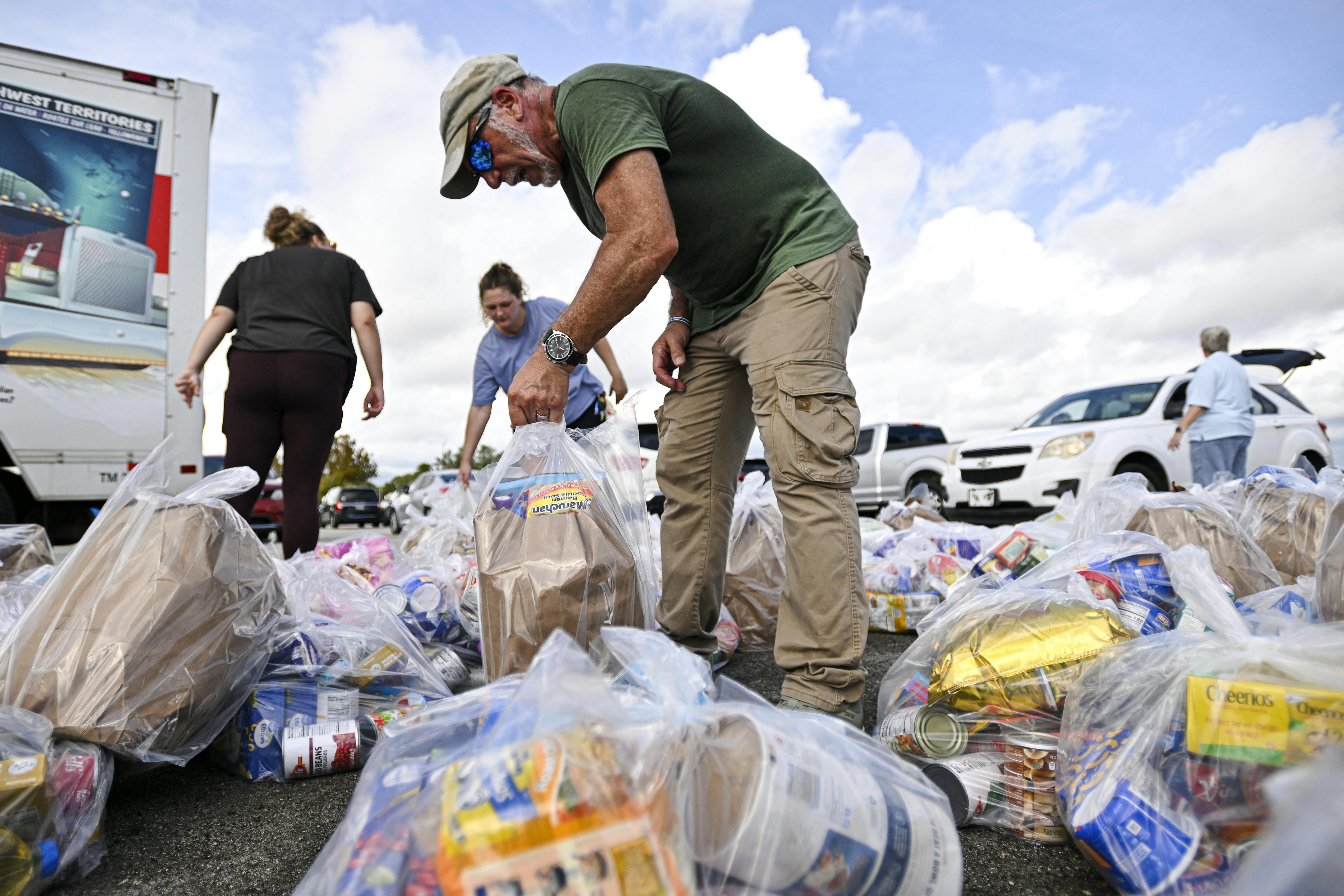 Volunteers organize bags of groceries at a food bank