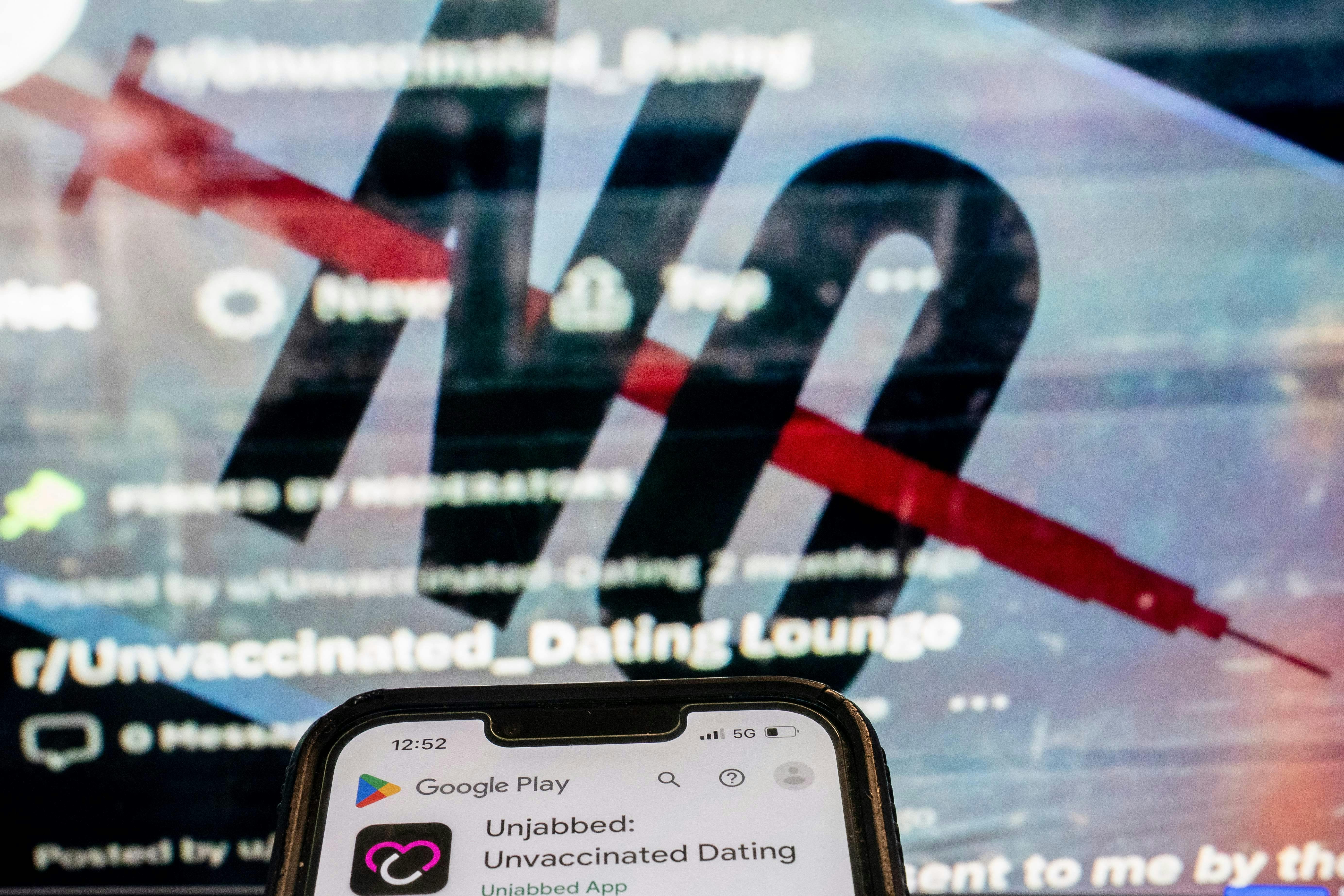 This photo illustration shows the "Unjabbed: Unvaccinated Dating" app in front of the cover image of a Facebook group for unvaccinated singles.