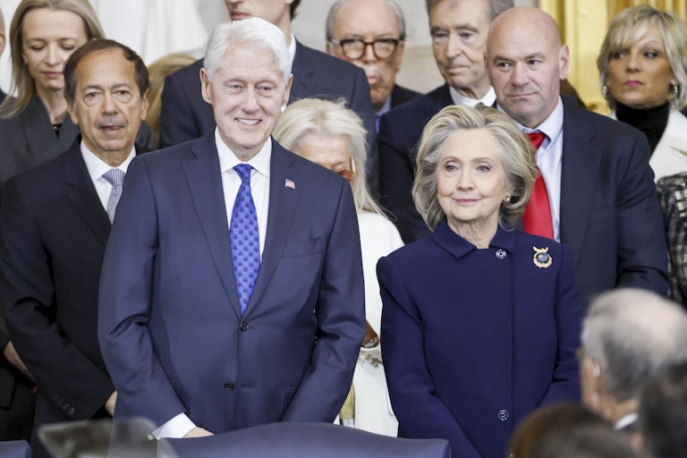 Hillary Clinton and Bill Clinton stand in a crowd