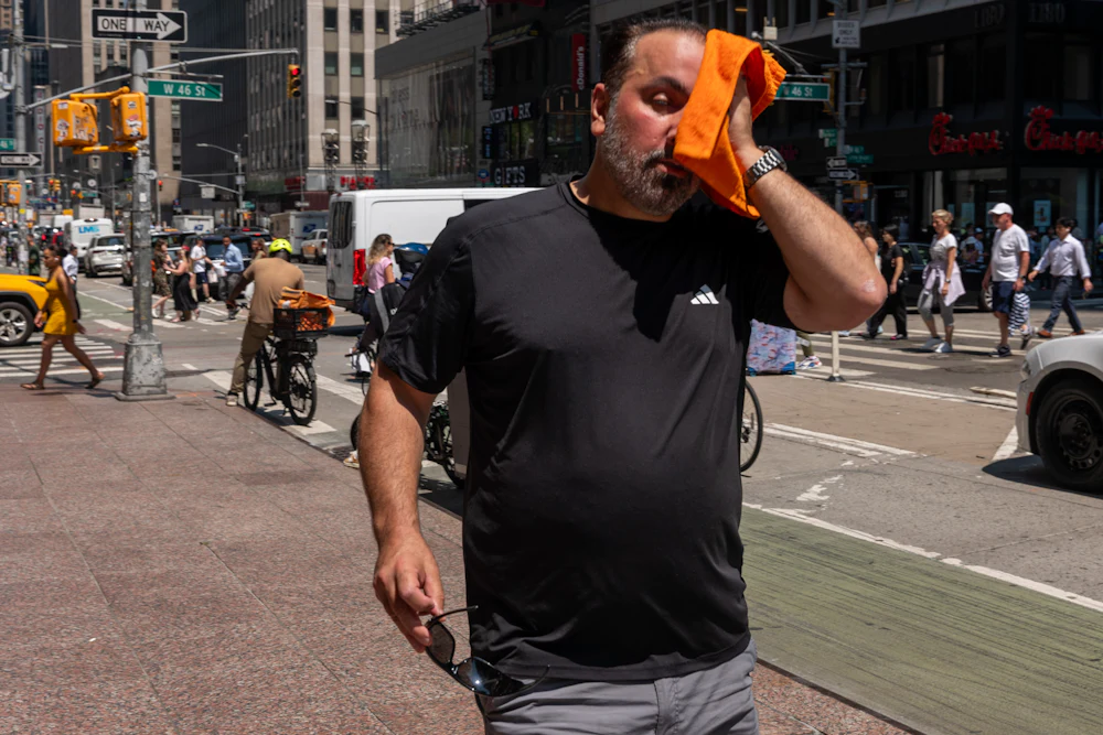 People try to stay cool on the sweltering streets of Manhattan as the region experiences another heatwave on July 29, 2025 in New York City.