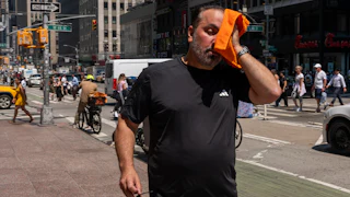 People try to stay cool on the sweltering streets of Manhattan as the region experiences another heatwave on July 29, 2025 in New York City.