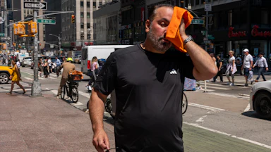 People try to stay cool on the sweltering streets of Manhattan as the region experiences another heatwave on July 29, 2025 in New York City.