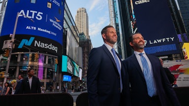 Donald Trump Jr. and Eric Trump smile as they stand outside of NASDAQ in Times Square