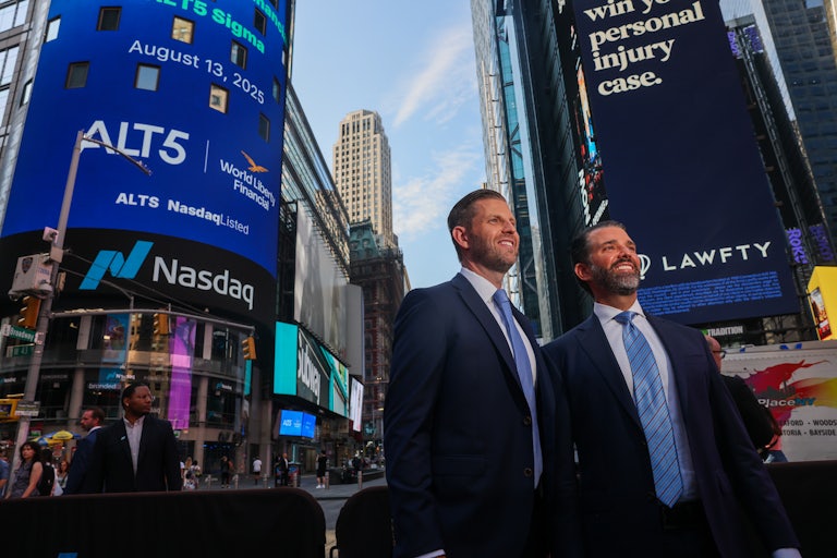 Donald Trump Jr. and Eric Trump smile as they stand outside of NASDAQ in Times Square