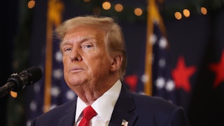 Republican presidential candidate and former U.S. President Donald Trump looks on during a campaign event in Waterloo, Iowa.