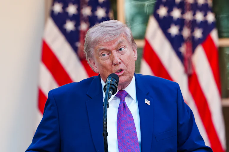 Donald Trump speaks into a microphone in the White House Rose Garden
