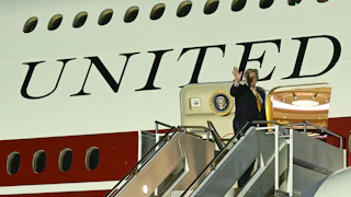 President Trump waves while boarding the new Air Force One on July 8.