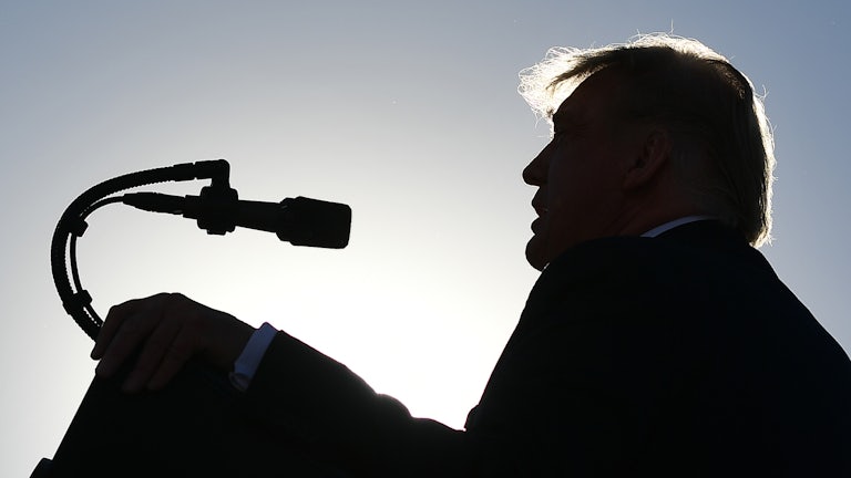 A silhouette of Donald Trump speaking at a campaign rally in Nevada