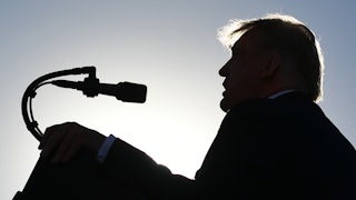 A silhouette of Donald Trump speaking at a campaign rally in Nevada