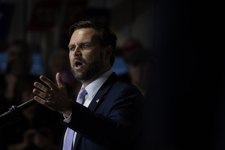 J.D. Vance speaking at a lectern at a campaign rally