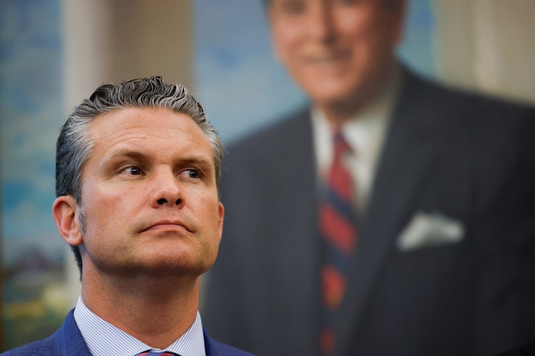 Defense Secretary Pete Hegseth stands in front of a White House portrait.