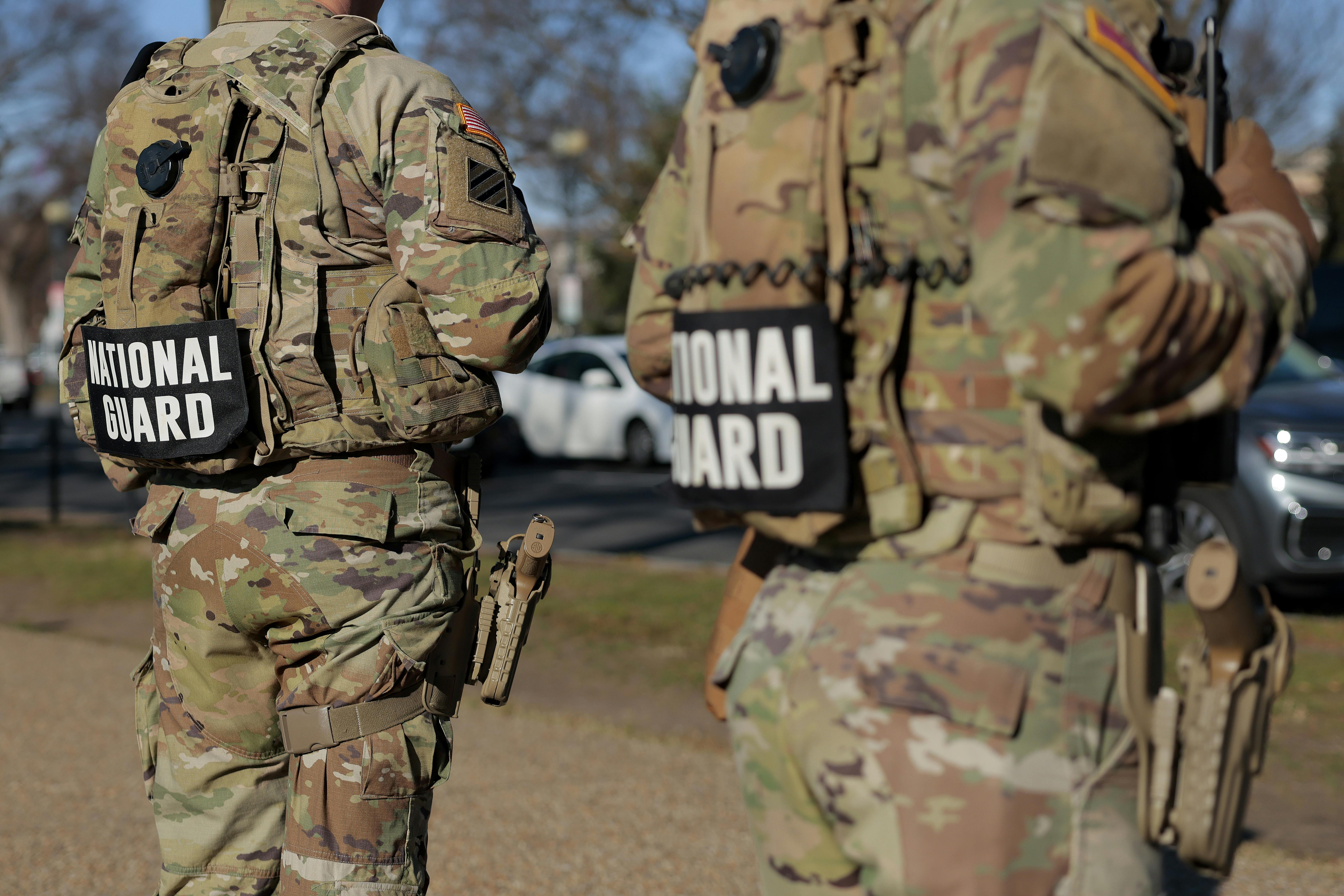 Members of the National Guard stand along the National Mall