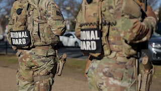 Members of the National Guard stand along the National Mall