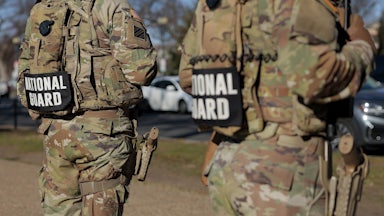 Members of the National Guard stand along the National Mall
