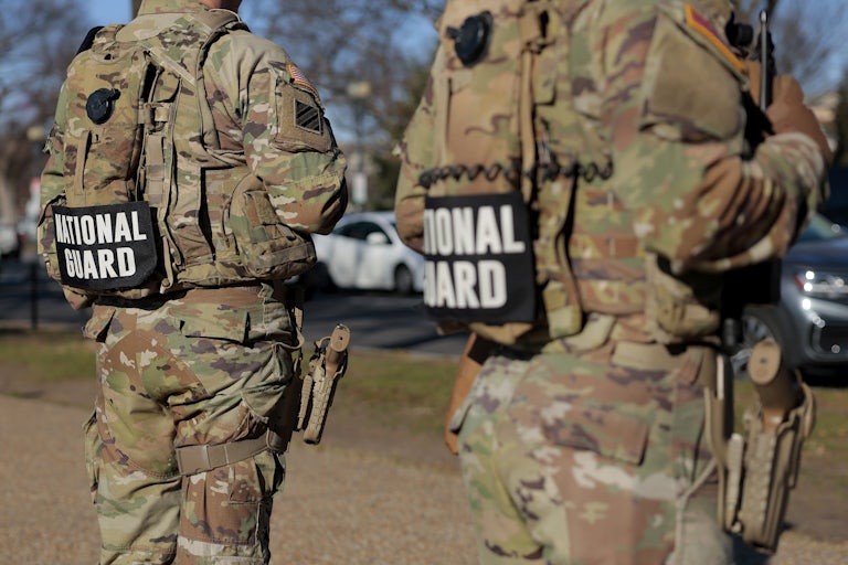 Members of the National Guard stand along the National Mall