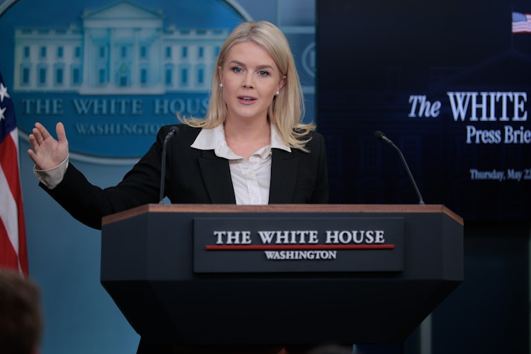 Karoline Leavitt gestures while speaking at the podium during a White House press briefing