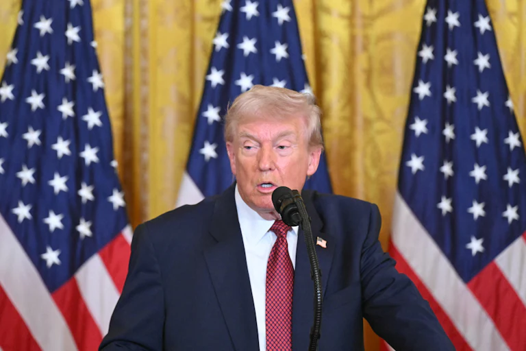 Donald Trump speaks at a podium.