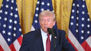 Donald Trump speaks at a podium.