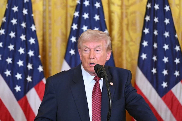 Donald Trump speaks at a podium.