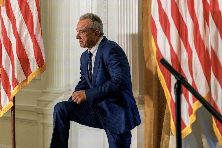 Robert F. Kennedy Jr. stands with one knee up