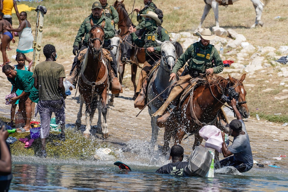 Border Patrol agents on horseback charge at Haitian migrants at the Rio Grande