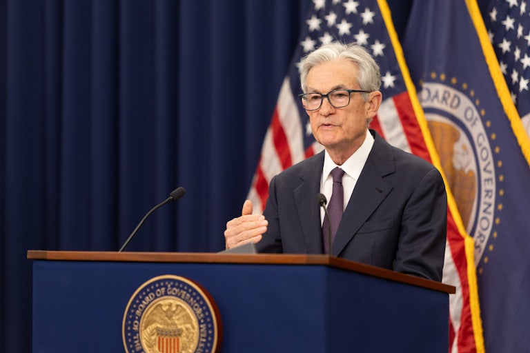 Federal Reserve Chair Jerome Powell gestures while speaking at a podium