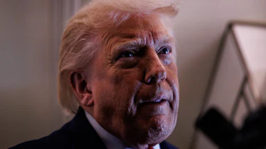 Donald Trump tucks his bottom lip and looks up while speaking to reporters on Air Force One