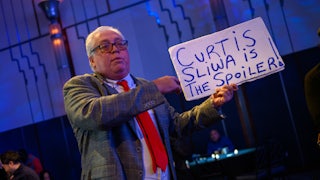 A man holds a sign that says, "Curtis Sliwa is the spoiler" at Andrew Cuomo's mayoral election night watch party