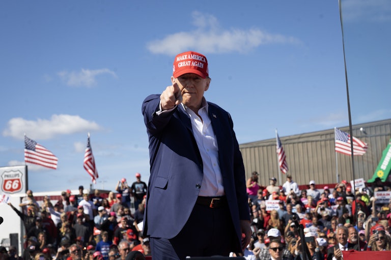 Donald Trump points into a camera during a campaign rally