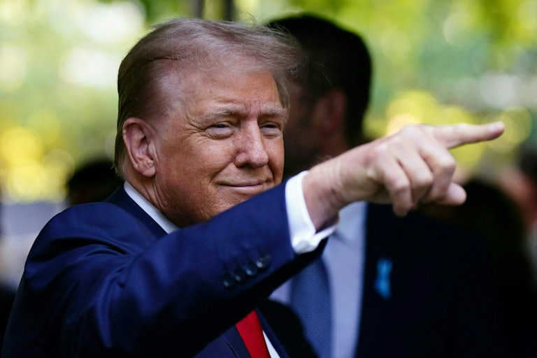 Donald Trump points while at a 9/11 memorial service