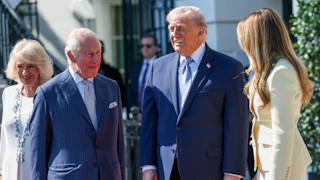 President Donald Trump and First Lady Melania Trump greet King Charles III and Queen Camilla at the White House, all of them smiling.