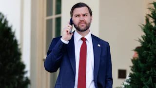 Vice President JD Vance holds his phone up to his ear while standing outside the White House