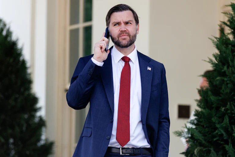 Vice President JD Vance holds his phone up to his ear while standing outside the White House