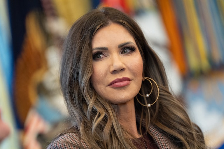 Homeland Security Secretary Kristi Noem looks to the side while standing in the Oval Office