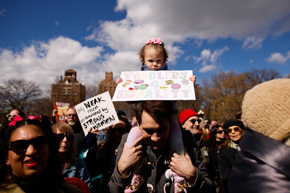 A little girl holds a sign during the International Women's Day march on March 8 in New York City.