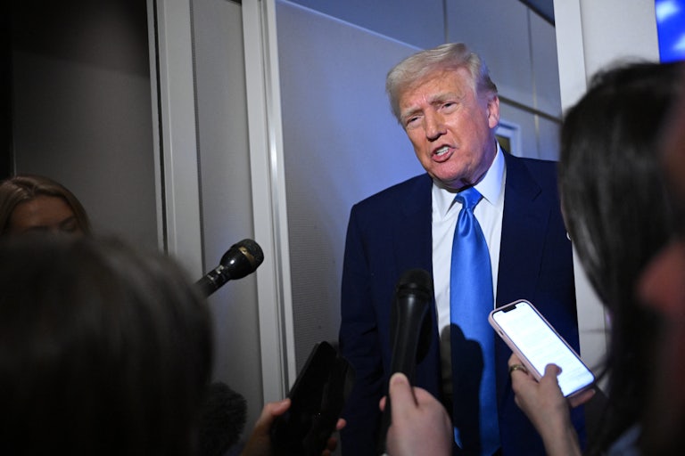 Donald Trump speaks to reporters on Air Force One