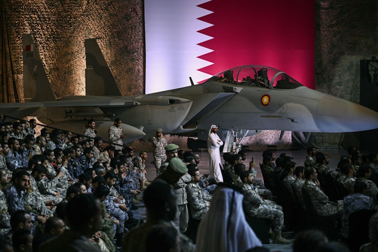 U.S. and Qatari troops and staff await Donald Trump at the Al-Udeid air base southwest of Doha.