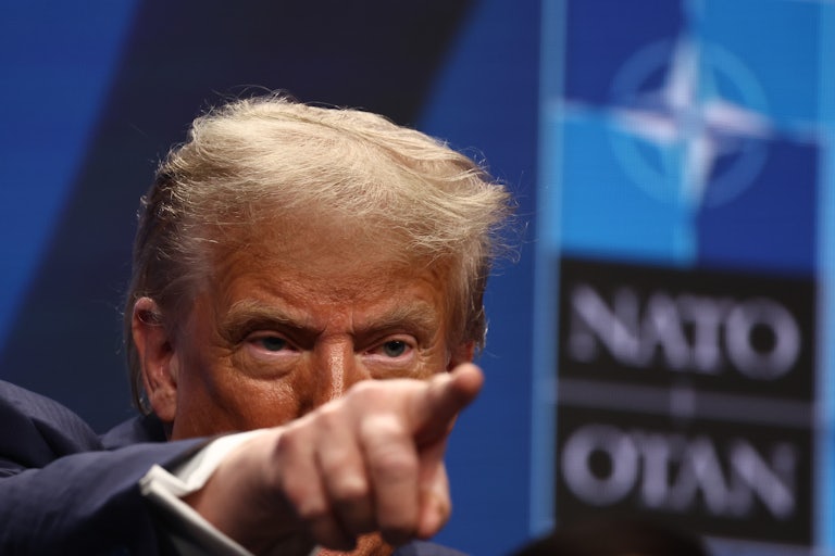 Trump points while conducting a press conference at the NATO smmit