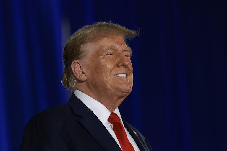 Donald Trump smiles (his spray tan on his face is incredibly obvious)