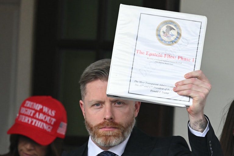 MAGA commentator Rogan O'Handley, also known as DC Draino, stands outside the White House and holds up a binder labeled "The Epstein Files: Phase 1"