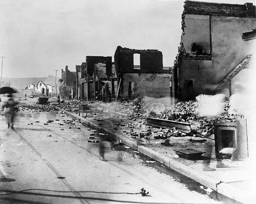 A black and white photograph the aftermath of the 1921 Tulsa Race Massacre
