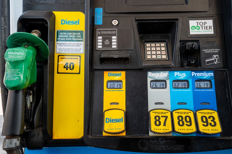 Prices per gallon are displayed at a gas station pump