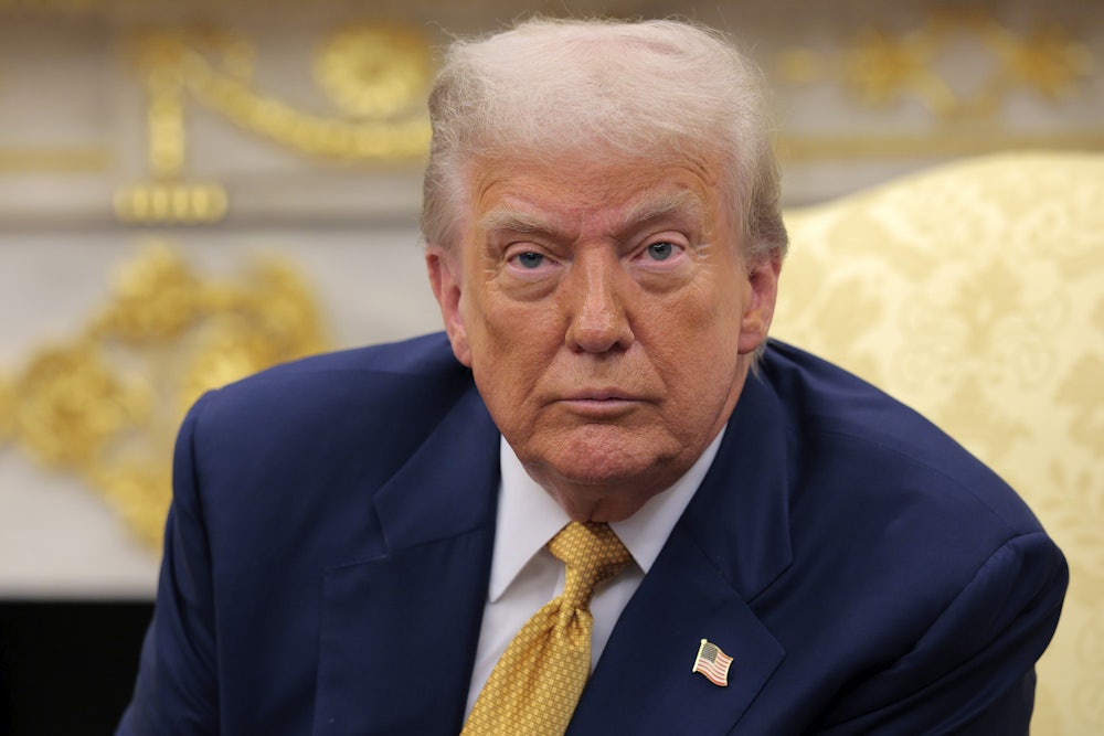 Donald Trump sits in the Oval Office and stares ahead with bloodshot eyes