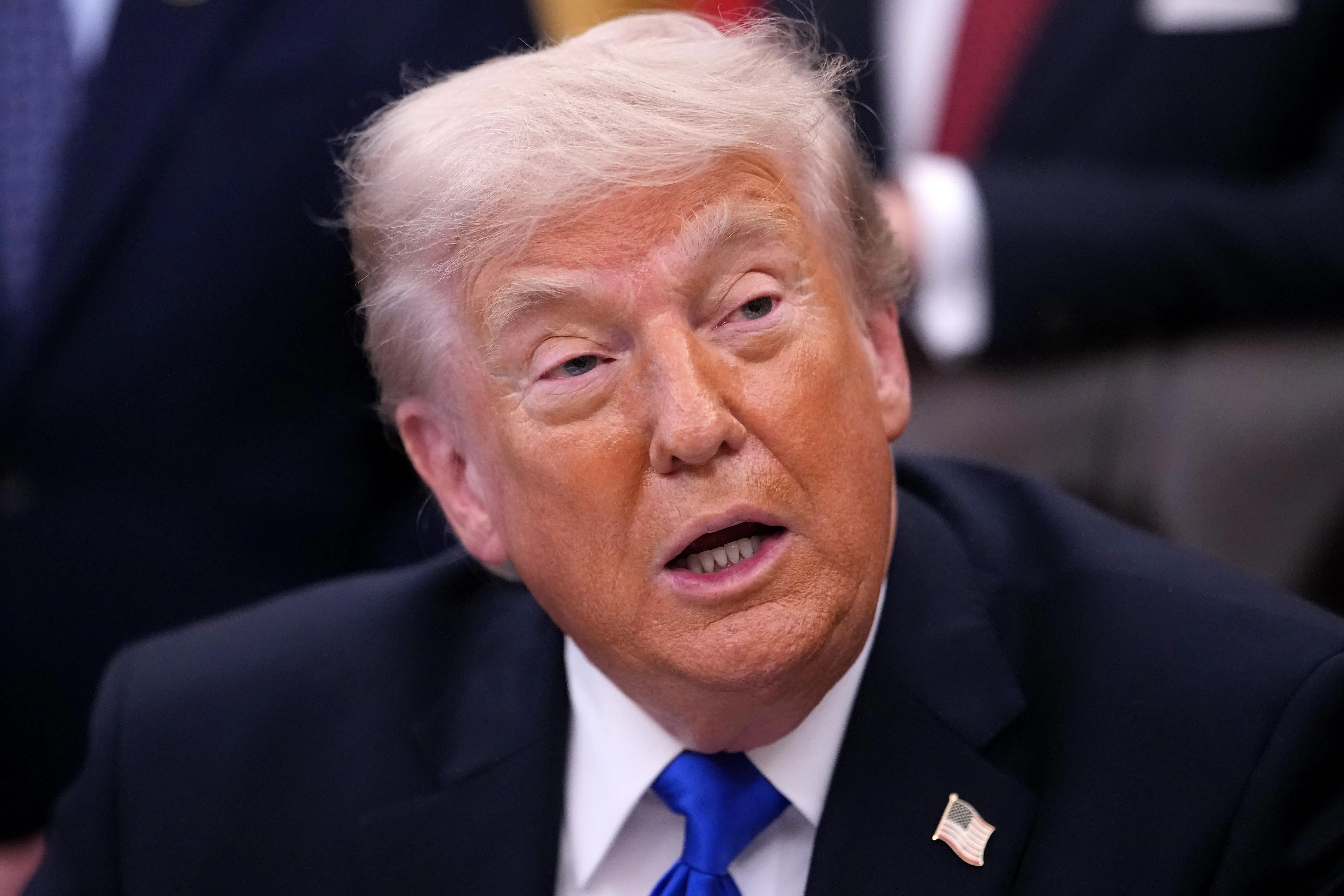 Donald Trump talks while sitting and looking tired